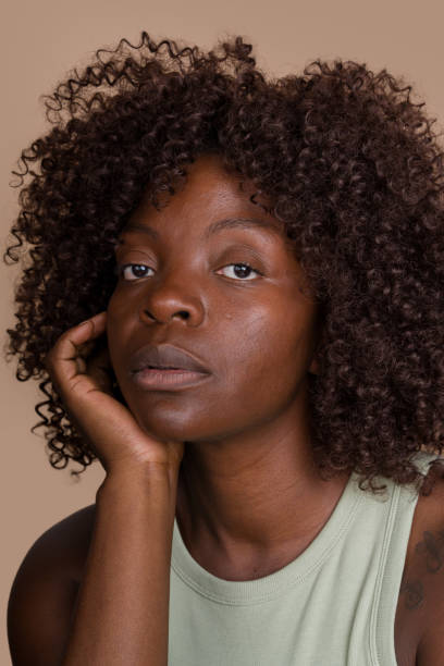 istock woman with afro hairstyle posing on beige background 2171054723