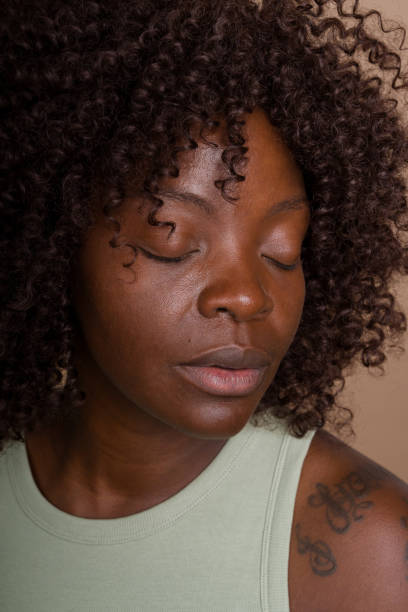istock woman closing her eyes in meditation 2171054794