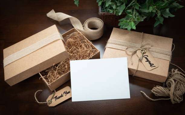Gift Packaging Boxes Mock Up with Jute String, Thank You and Congratulations Card and Tags with Small Key on Wood Surface.