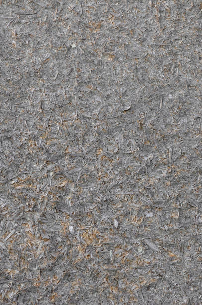 istock Old natural aged weathered oriented strand board OSB chipboard texture, grungy grey horizontal pattern, vertical rustic macro closeup, large detailed dark textured grunge ruined wooden background copy space, black, taupe, tan, brown, yellow beige detail 2171055986