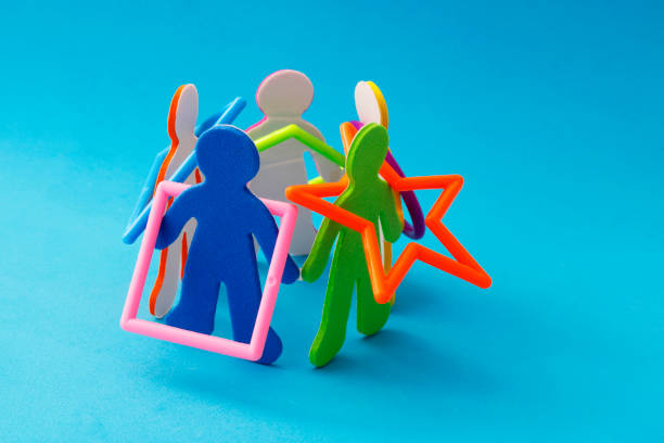 Silhouettes of people forming a circle playing with plastic figures
