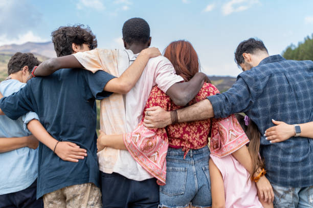 istock Diverse friends embracing outdoors, unity in multicultural group, togetherness in nature, inclusive community 2171057672
