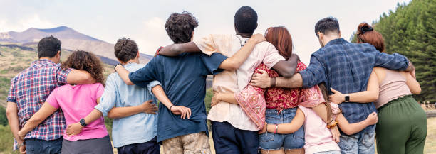 istock Diverse group hugging, panoramic view of multicultural friends embracing, unity and togetherness concept 2171057673