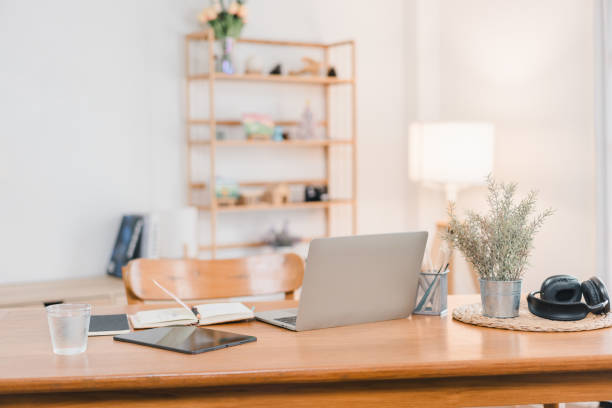 istock A modern workspace featuring laptop, tablet, notebook, and decorative plants, creating serene and productive atmosphere. warm lighting enhances inviting feel of room. 2171060254
