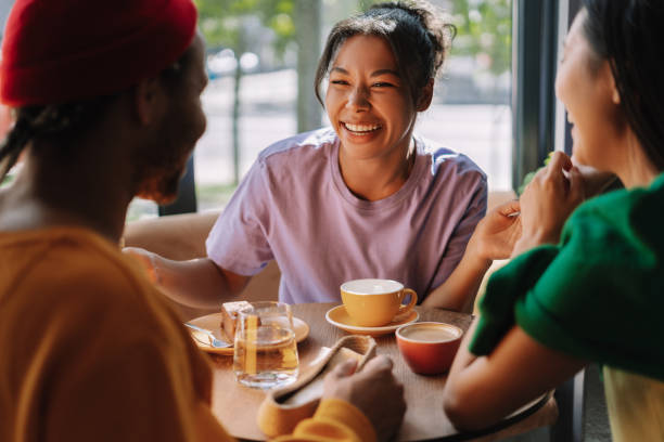 istock Diverse, multinational friends enjoying coffee and conversation at a cafe 2171063814