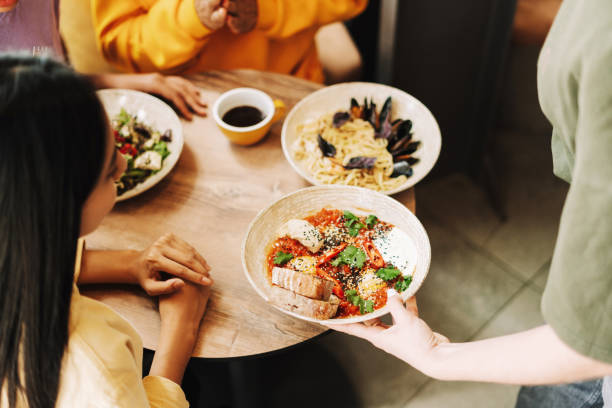 istock Waitress serving food to customers in restaurant selective focus 2171063860