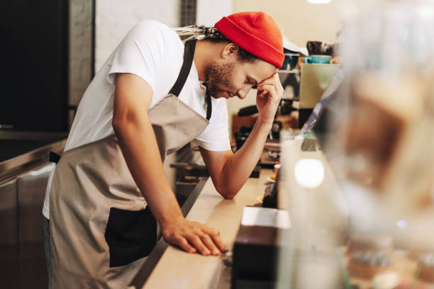 istock Young latin barista feeling stressed while working in coffee shop 2171064973