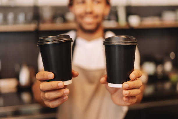 istock Barista holding two black paper coffee cups, selective focus, closeup, mockup 2171064987