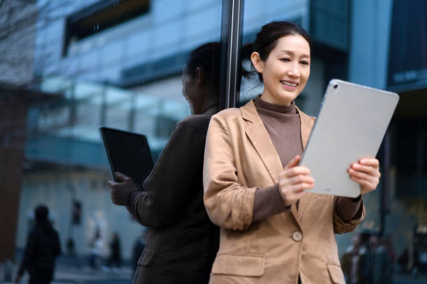 istock Professional Woman Engaged with Tablet in Urban Environment 2171070147