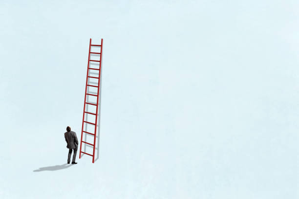 istock Man Looking Up At Tall Ladder 2171072422