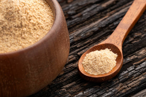 Peruvian organic maca powder - Lepidium meyenii in the bowl and spoon Organic Peruvian maca powder in the bowl and spoon - Lepidium meyenii pachyrhizus erosus stock pictures, royalty-free photos & images