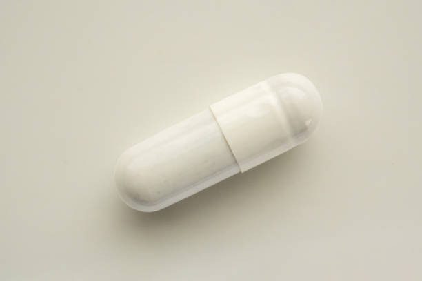 istock White herbal medicine capsule on white background 2171076393