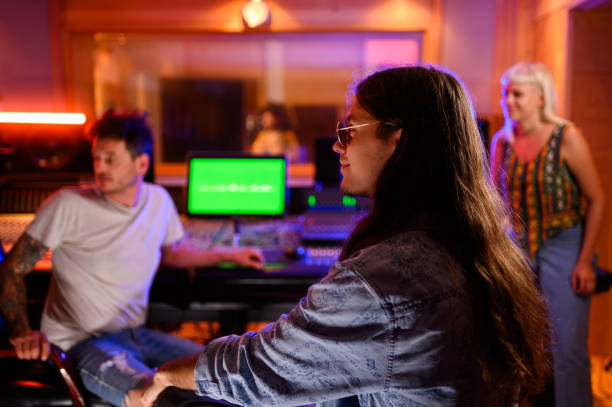 istock Group of musicians having consultations with sound engineer at recording studio 2171076989