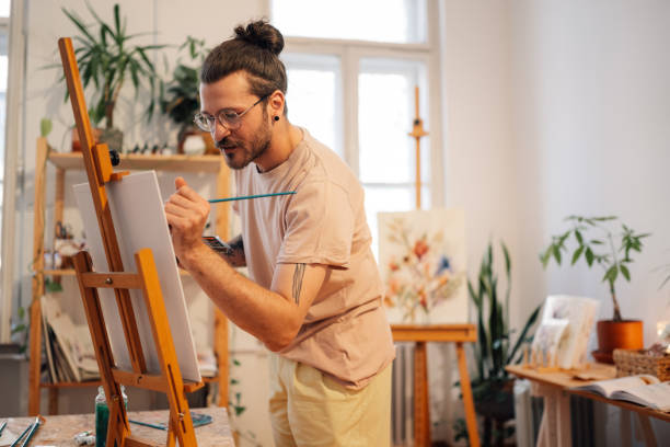 istock Skilled author painting with brush on easel at creative atelier. 2171077050