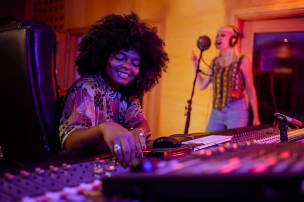 istock Hispanic latino female sound engineer working with a singer in her studio 2171077086