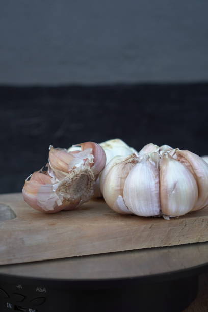 istock Fresh garlic cloves on a wooden cutting board 2171083257
