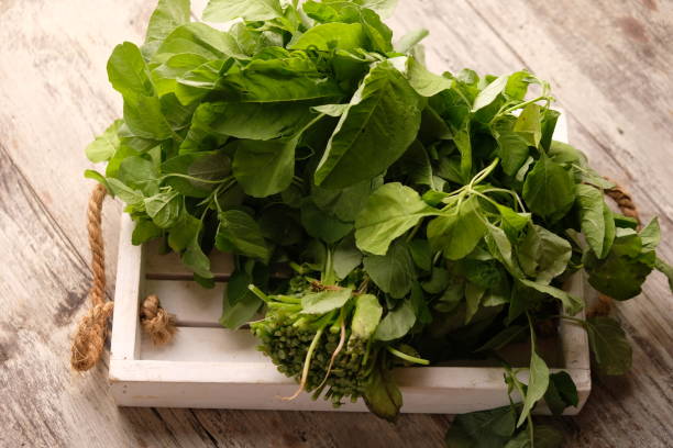 istock Spinach (Amaranthus) is a plant that is commonly grown for its leaves as a green vegetable. spinach on a white wooden tray. 2171084621
