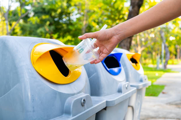istock Please throw plastic bottles in the bin. Man littering the bins by separating waste for disposal such as recyclable plastic waste. environmental concept 2171084774