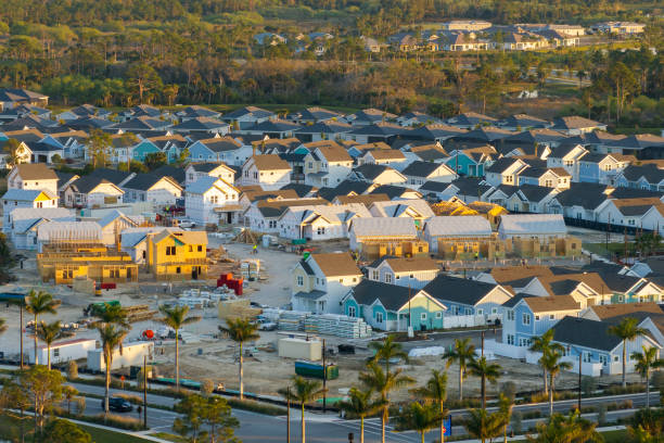 istock Construction in new developing suburban area. Development of residential housing in American suburbs. Real estate market in the USA 2171084984