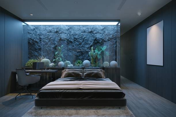 istock a modern bedroom featuring a bed, plants, and a wall with a rock-like texture. 2171088008