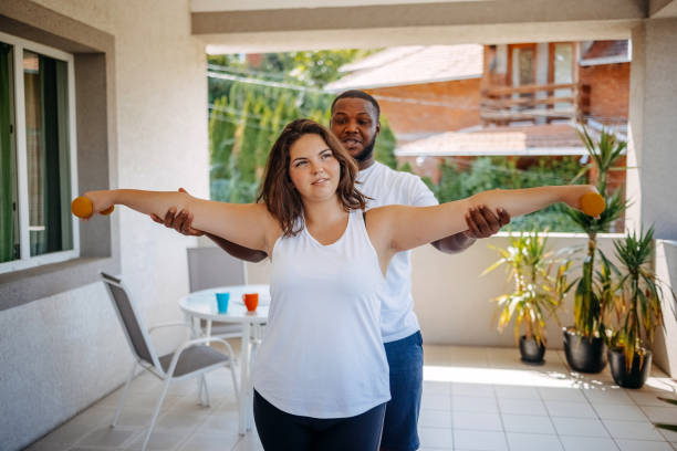 istock Young couple enjoying spending time together at home while exercising on balcony 2171094031
