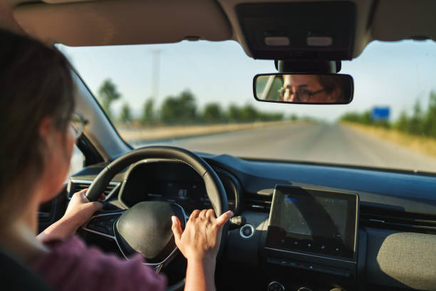 istock Woman driving car on a highway. 2171094674