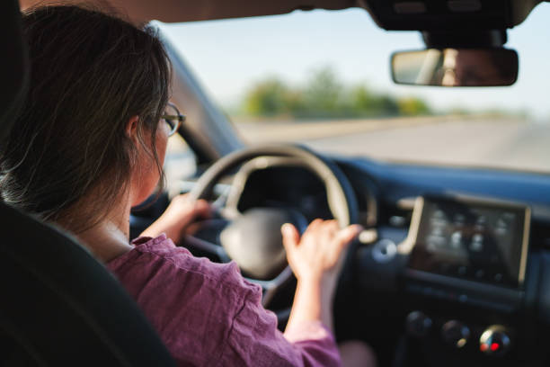 istock Woman driving car on a highway. 2171094737