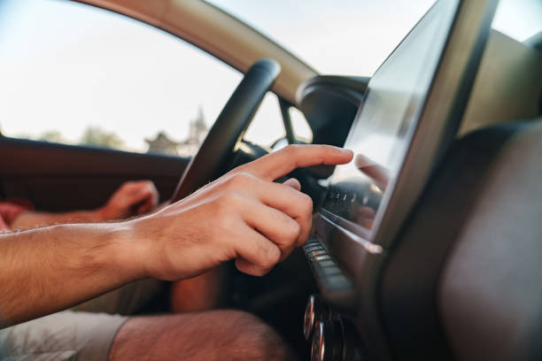 istock The driver is touching the electronic display screen on the car's dashboard. 2171095826