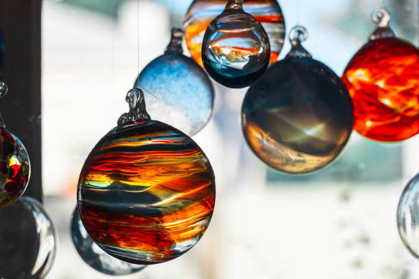 istock Decorative glass balls hang in front of bright window 2171095907