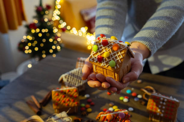istock A woman is holding a DIY Gingerbread house 2171096523