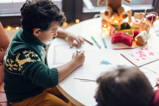 istock A child drawing at a festive table 2171096614
