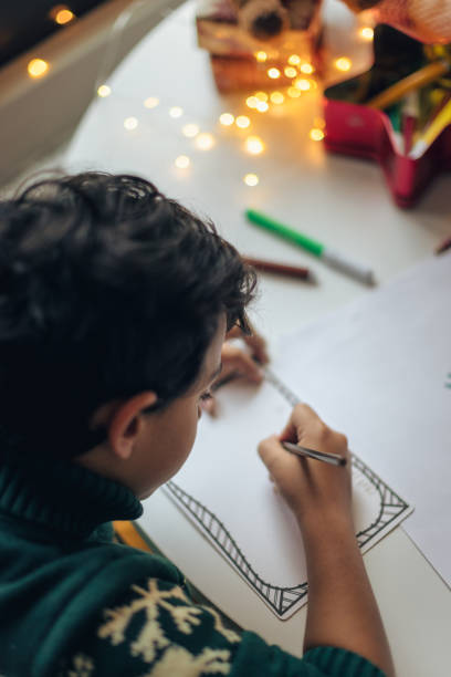 istock Child Drawing at Cozy Table During Evening 2171096617