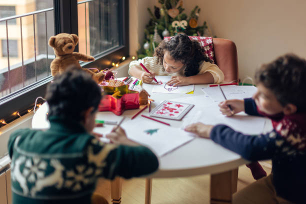 istock Children Drawing Christmas Cards Indoors 2171096621