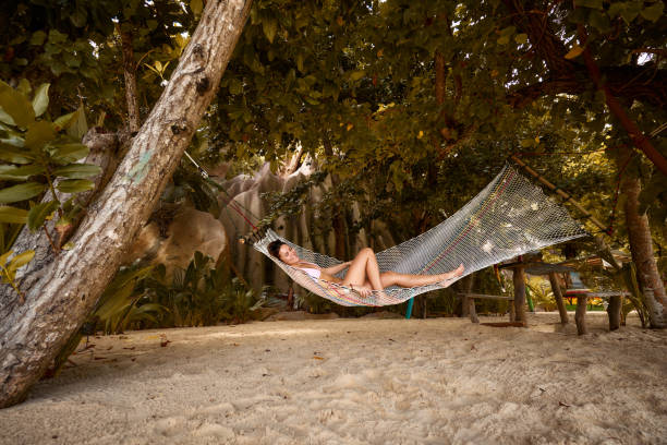 istock Happy woman relaxing in hammock on the beach. 2171096811