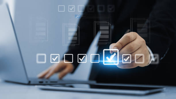istock Person checking list quality document and counter product approval the correct selection boxes.Productivity checklist,filling survey form online,fast checklist and clipboard task business management. 2171098550