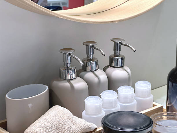 istock A bottle of liquid soap pump on the table and various small cream bottles in front of the bathroom mirror. 2171098708