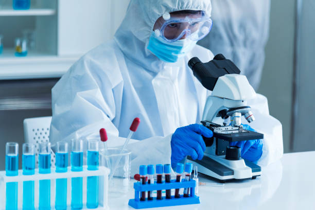 istock Scientist man look into Microscope research in science laboratory. Asian scientist look at microbiology microscope laboratory equipment chemistry lab. Biochemistry research experiment vaccine concept 2171098712
