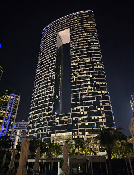 istock Modern skyscraper with unique architecture illuminated at night in a bustling urban environment concept 2171101748