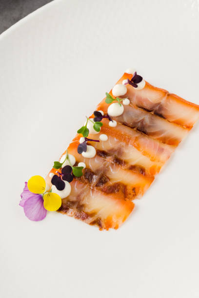 istock Smoked fish pastrami or bacon on a white porcelain plate 2171103595