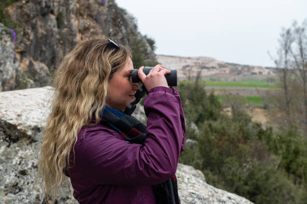 istock A young girl observing in nature with binoculars. 2171105239