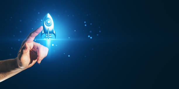 istock Hand holding glowing rocket symbol on dark blue background for startup concept. 2171106694