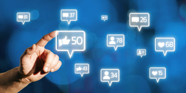 istock Hand interacting with glowing social media icons on blue background. 2171106716