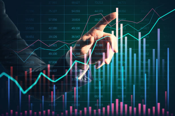 istock Businessman's hand pointing at financial graphs on a virtual screen, indicating market trends and data analysis. 2171106765