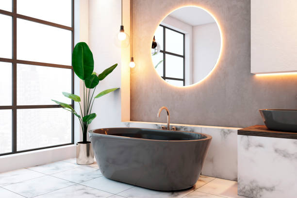 Modern bathroom interior with round mirror and black bathtub. 3D Rendering
