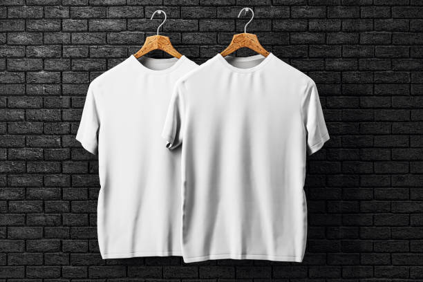 istock Two white t-shirts on wooden hangers against a black brick wall. 3D Rendering 2171108542