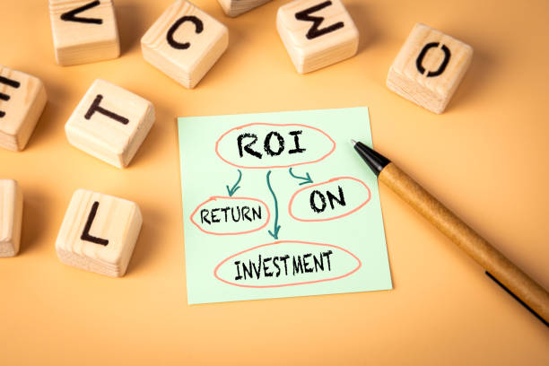 istock ROI Return on investment. Notepad and wooden alphabet letters on a light background 2171108776