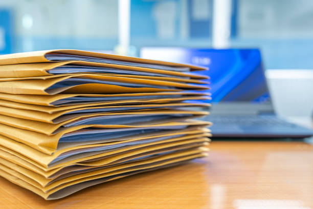 istock Stacks of Brown envelope, piles of unfinished documents, Business report papers, Using scanner machine for convert document to digital data storing into computer. 2171110249