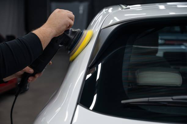 istock Process of polishing white car body surface using orbital polishing machine. 2171111711