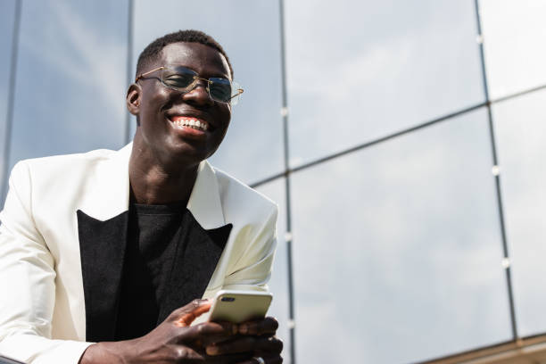 istock Content black businessman with smartphone on city street 2171111802
