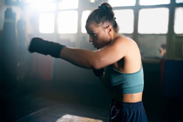 istock Female kickboxer, shadowboxing, during an kickbox practice in the gym 2171113643